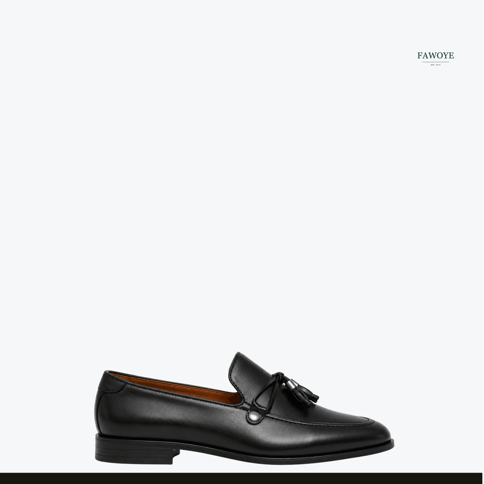 Black tassel loafers worn with tailored trousers