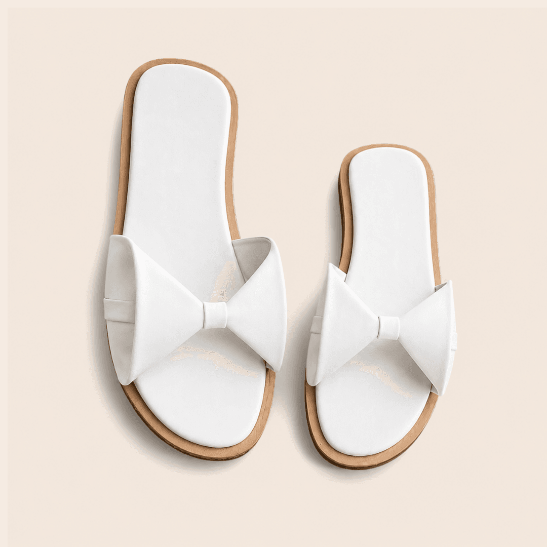 White bow-detail slide for a bride’s reception or after-party